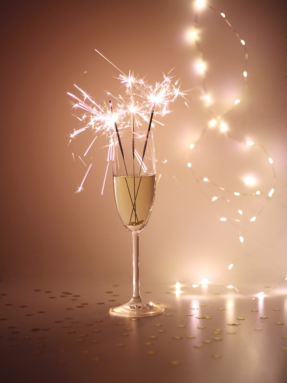 a group of hands holding sparklers